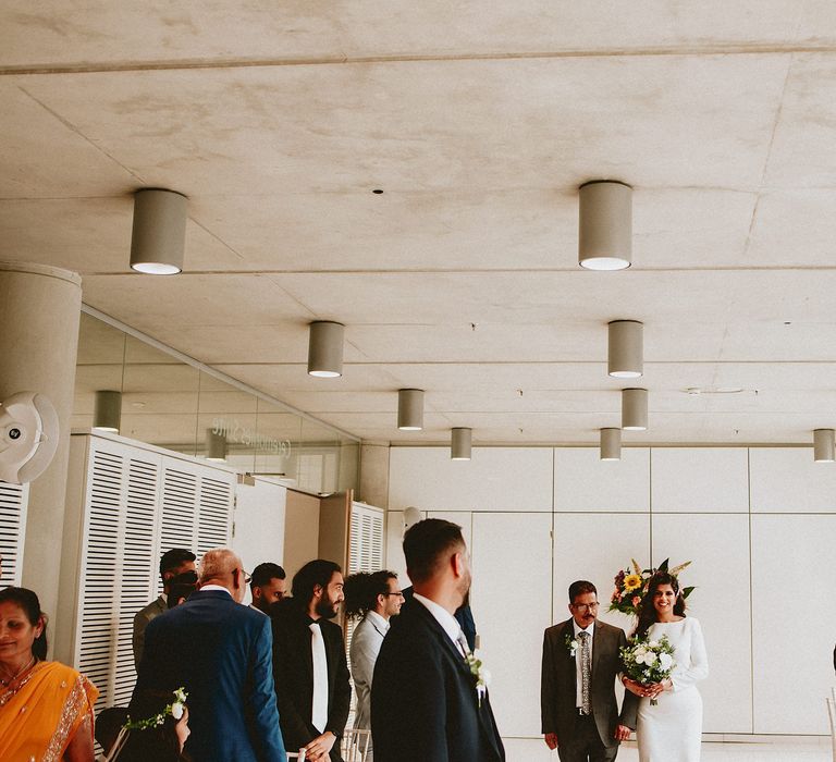 Brent Civic Centre wedding ceremony bridal entrance in a fitted wedding dress with long sleeves 