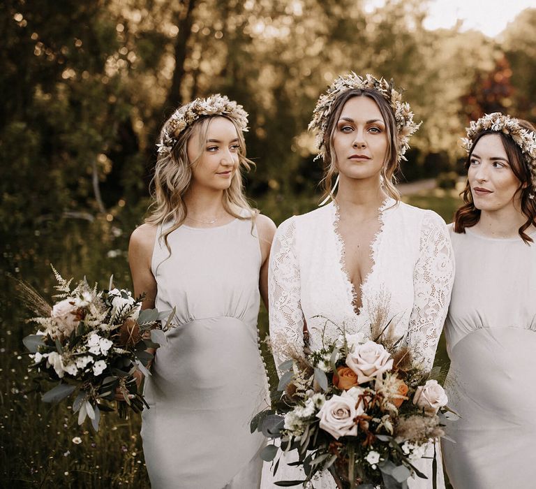 Bride and bridesmaids with natural makeup and wavy wedding hairstyles and dried flower crowns 