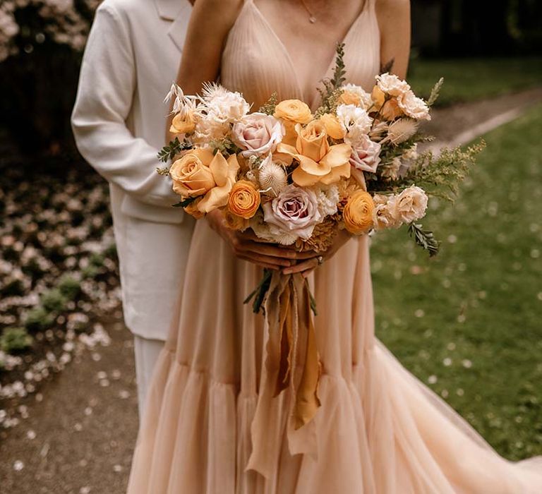 Honey yellow and blush pink wedding bouquet with peeled back roses 