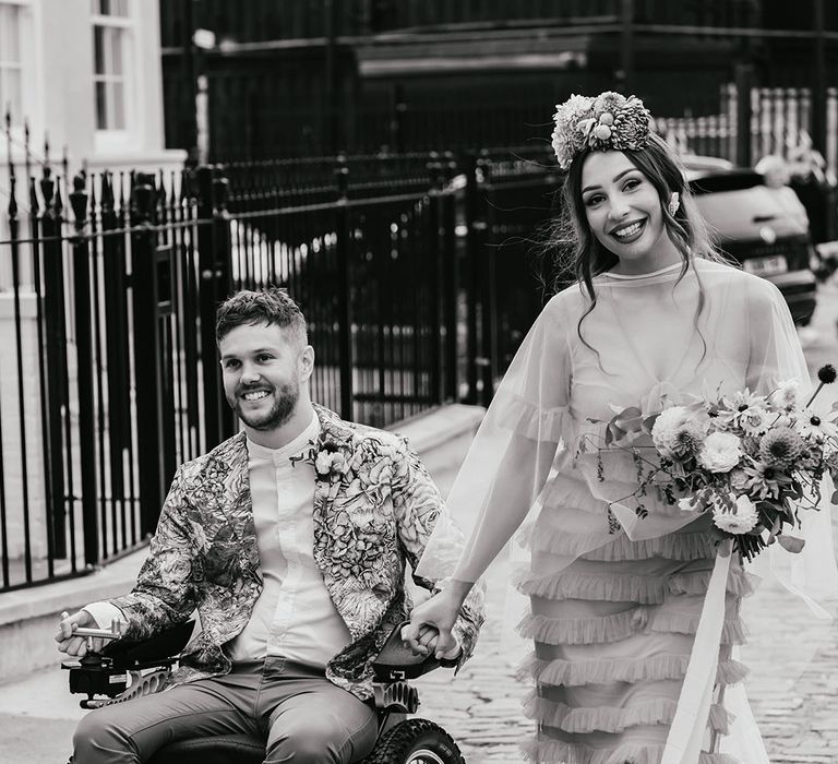 Black and white poortrait of an interabled couple holding hands at their Shoreditch elopement 