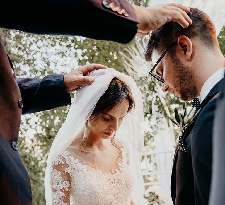 Bride during Christian Evangelic Ceremony wedding lace wedding veil  | Royal Studio