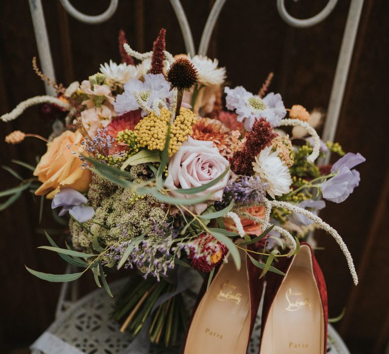 Christian Louboutin wedding shoes with pastel bouquet for bride