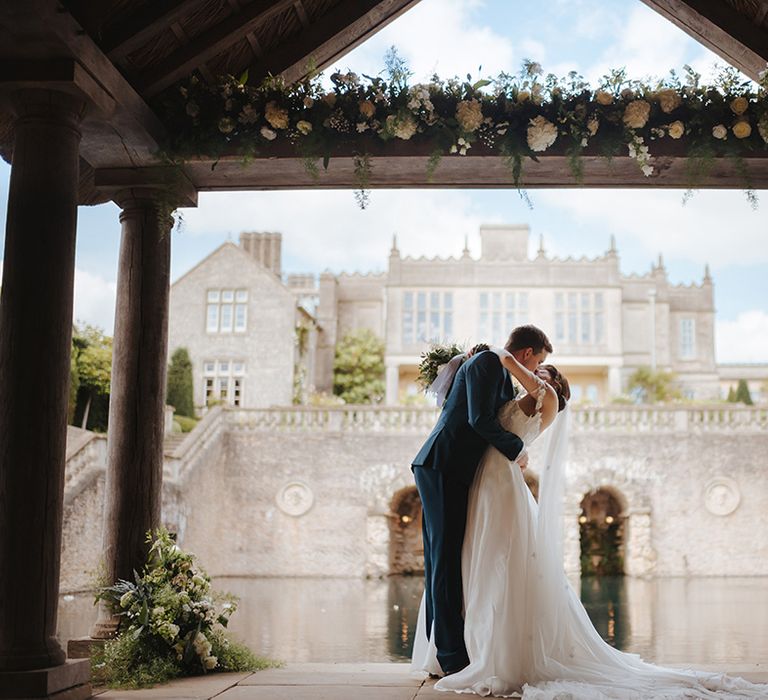 Bride & groom kiss on their wedding day outdoors