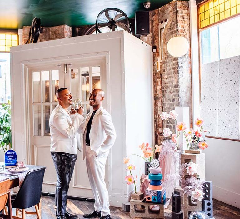 Stylish industrial wedding at Coin Laundry, Exmouth Market with two grooms in monochrome and mens sequin suit