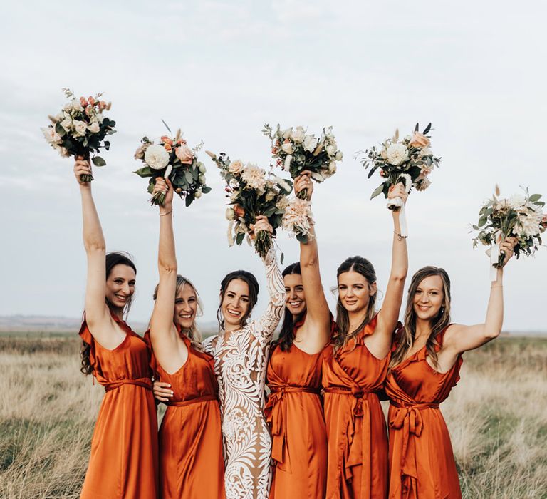 Bridal party in silk long one ruffle bridal dresses open champagne with Bride in Lacy detail wedding dress 