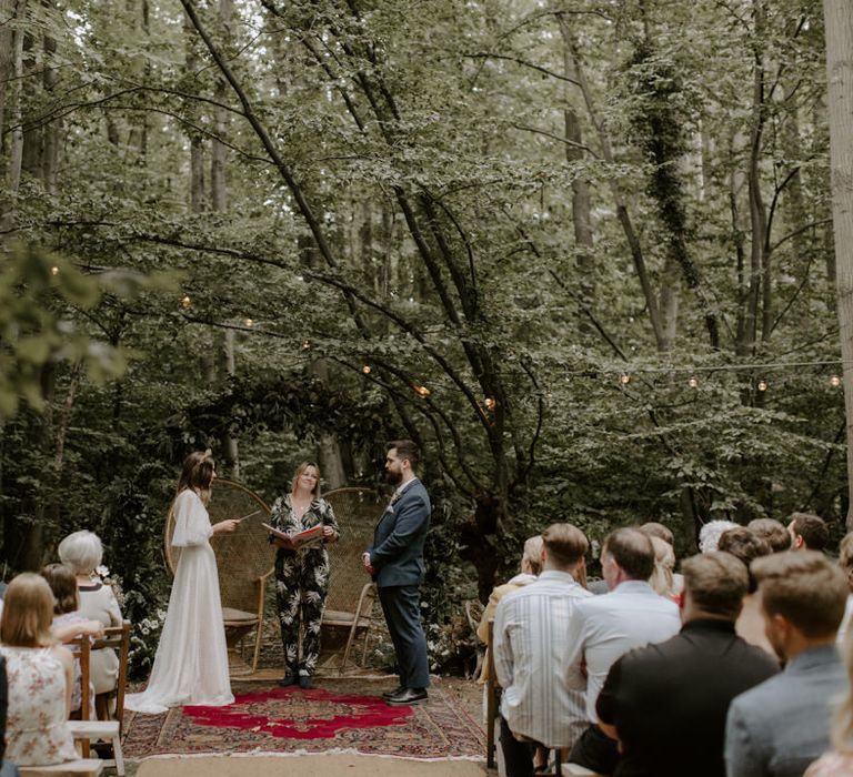 Bride & groom stand opposite one another during wedding ceremony at The Dreys