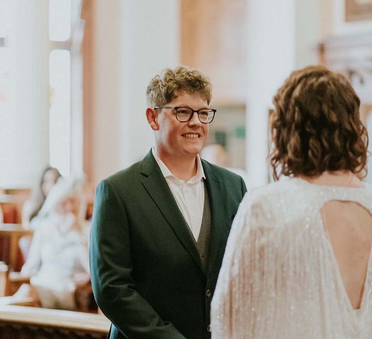 Groom wears green jacket for wedding ceremony