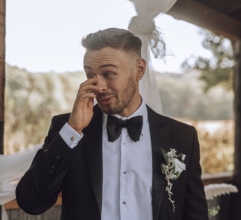 Groom wears black tie on his wedding day