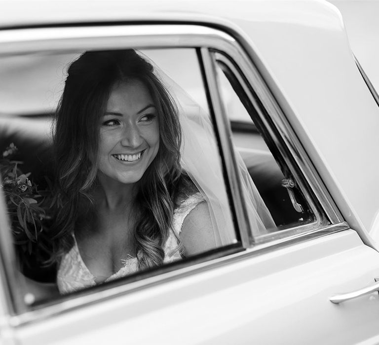 Bride in vintage wedding car