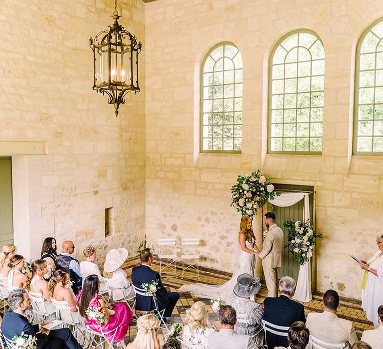 Bride & groom during ceremony at French Chateau 