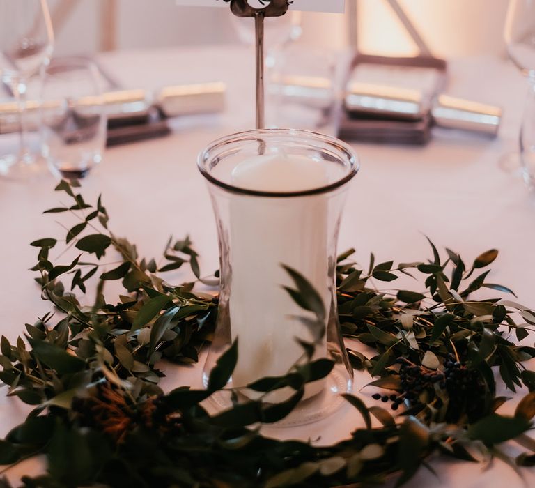 Table centrepiece complete with table names, candle and floral decor 