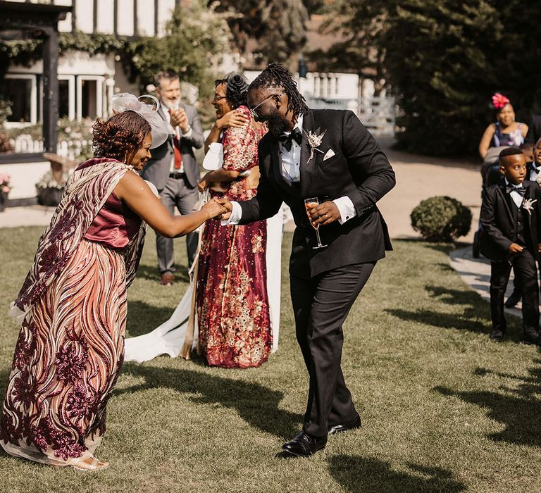 Groom greets wedding guest on his wedding day