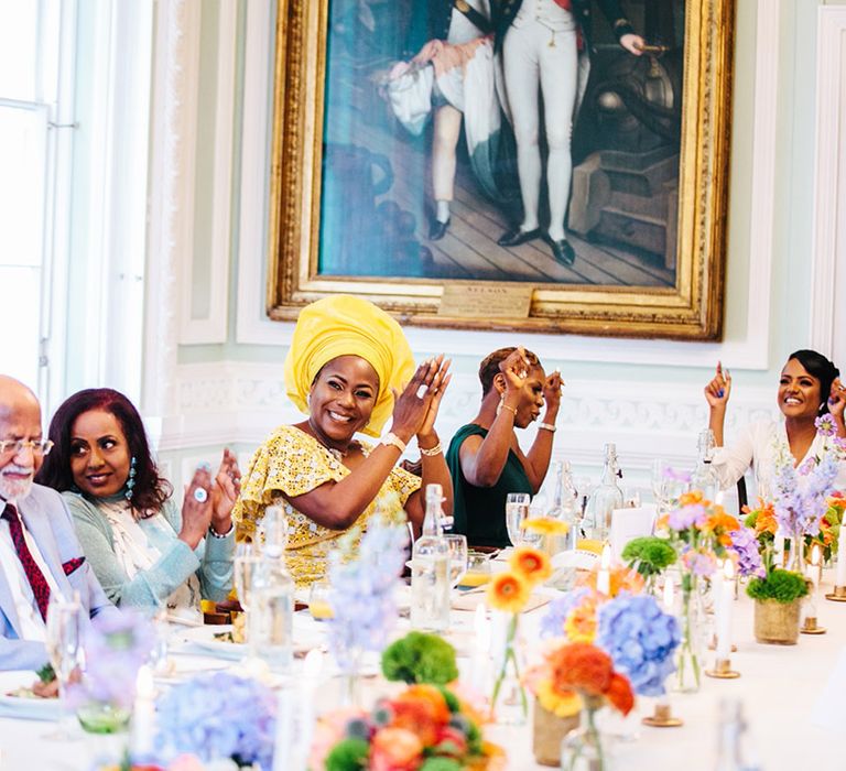 Wedding guests clap on wedding day during reception