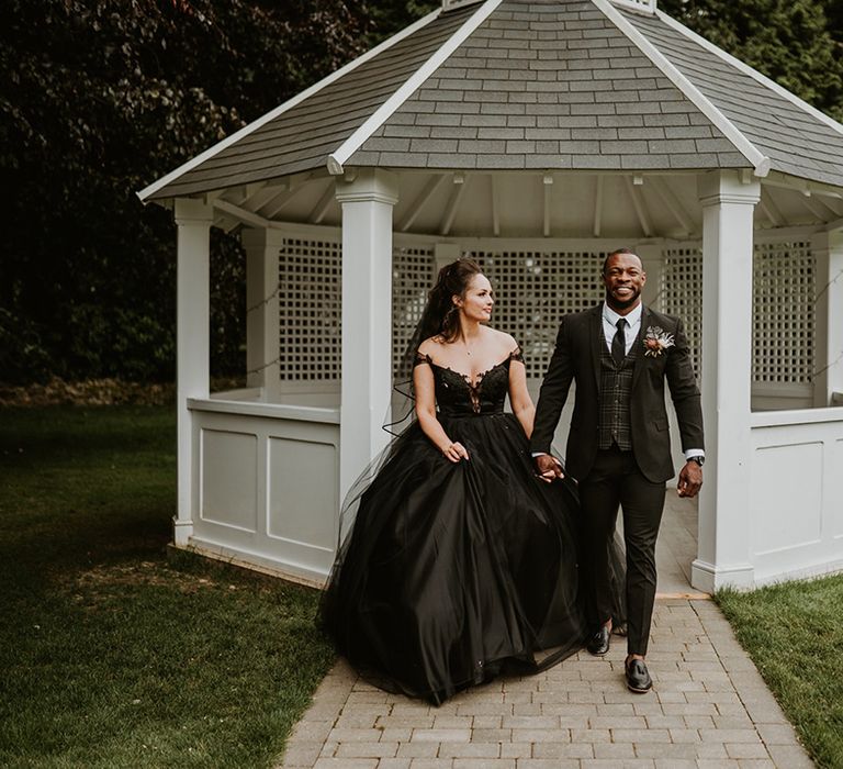 Bride & groom walk with one another on their wedding day