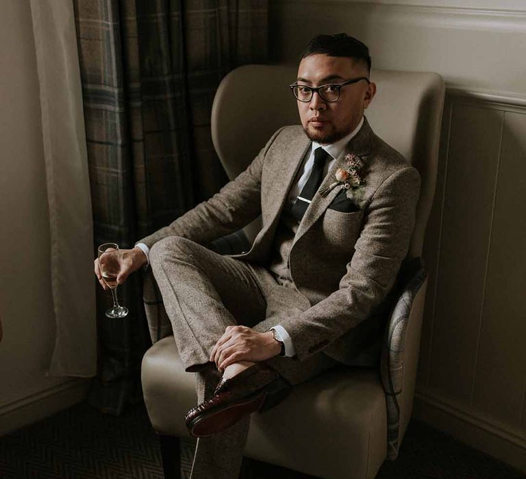 Groom in Tru Clothing outfit, GH Bass x Maharishi shoes, and a neutral boutonniere