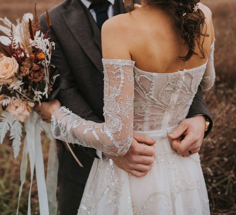  Bridal updo hairstyle for rustic wedding with groom in dark grey suit