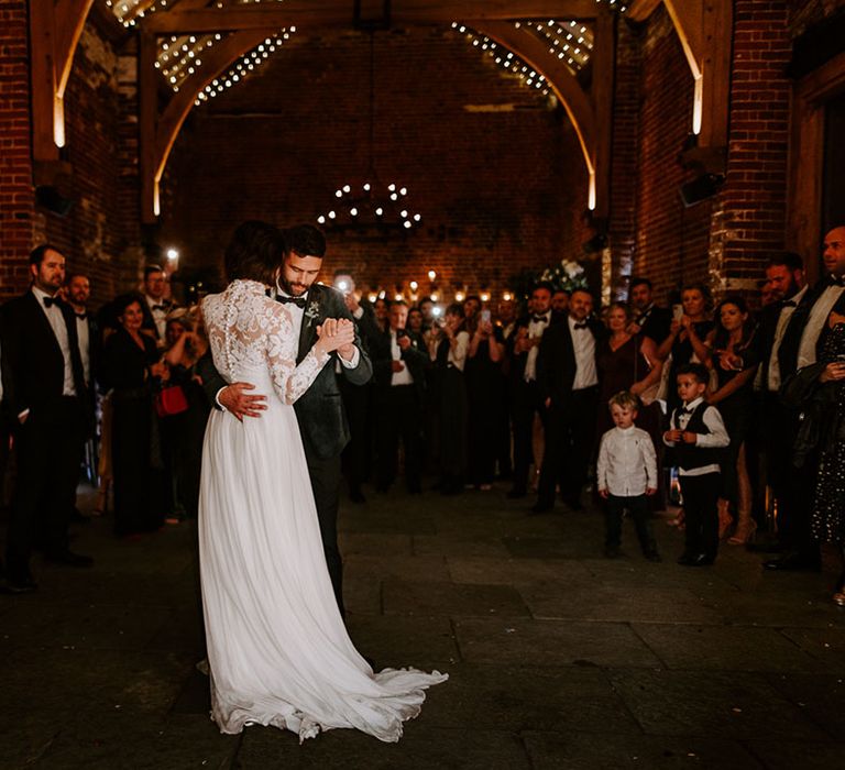 Bride and groom have their first dance under twinkling fairy lights at Hazel Gap Barn 