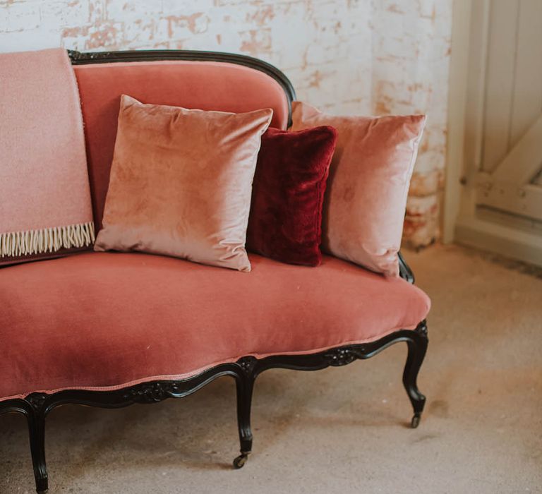 vintage pink suede ornate sofa and scatter cushions at Prestwold Hall Barns 