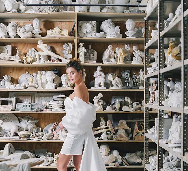 Bride in short wedding dress with off the shoulder bow detail wearing white lace up wedding shoes