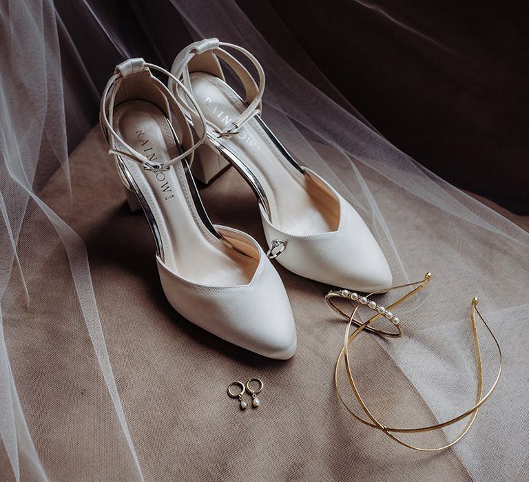 Rainbow Club white wedding shoes with gold headband, pearl earrings, diamond engagement ring, and pearl bracelet 