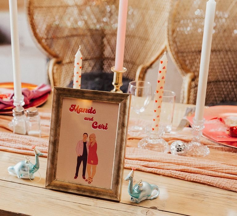 Retro style table name with pink and white candles with white heart candles, heart mug and bauble decor