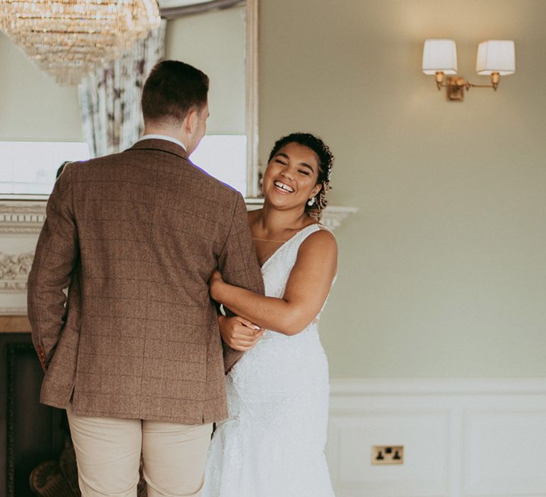 Bride and groom laugh together for their classic wedding in Bedford 