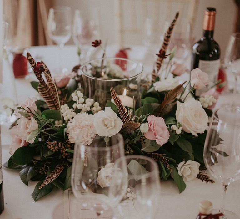 Pastel floral centrepiece complete with candle to the middle 