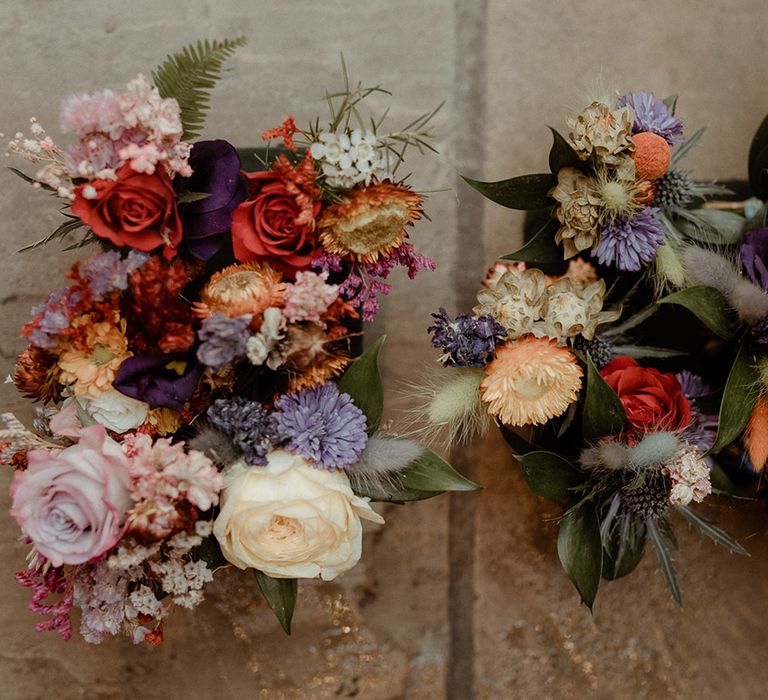 Pretty pink, purple, red, and blue bouquets with bunny grass and roses 