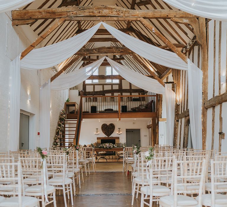 Dove Barn Weddings venue decorated with white drapes and fairy lights in Suffolk 