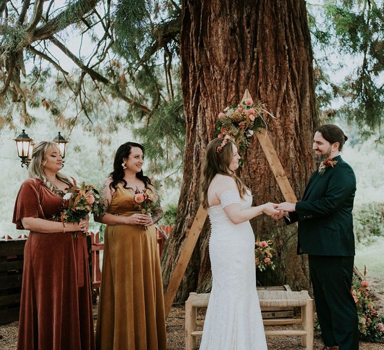 woodland wedding under a Sequoia tree with wooden triangle frame altar