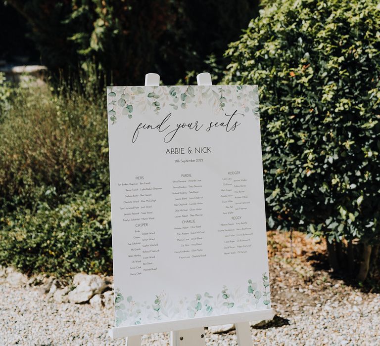 green and white seating chart on an easel 