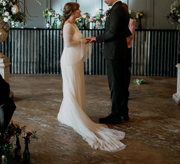 Industrial Holmes Mill wedding venue with the bride and groom standing at the altar for their civil wedding ceremony 