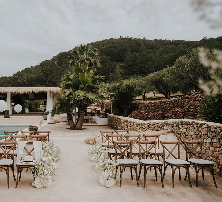 poolside wedding ceremony at pure house ibiza with giant white balloons and white aisle flowers