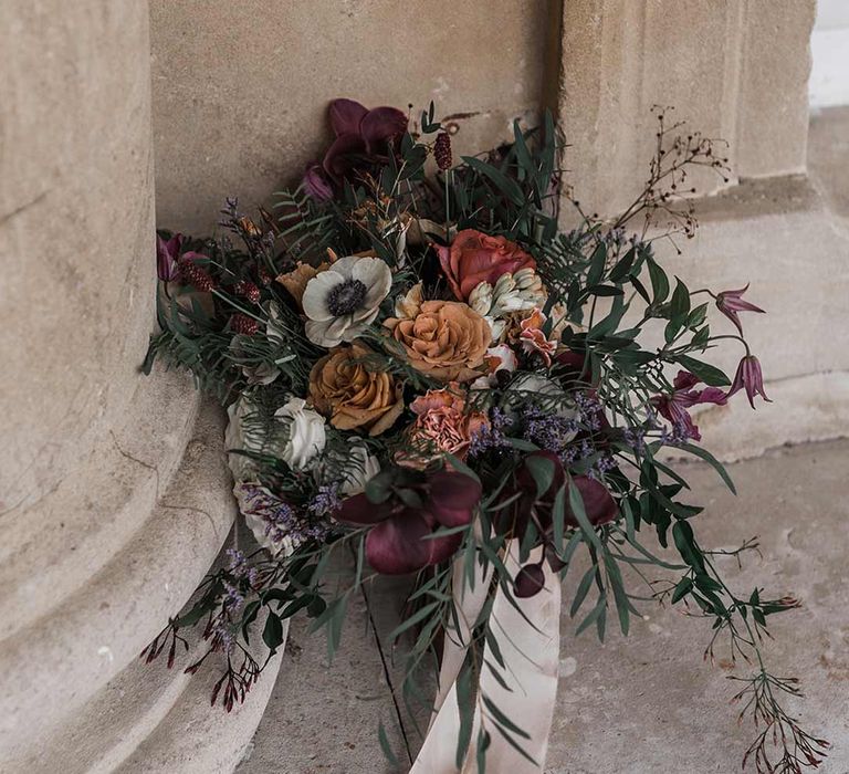 Dried wildflower wedding bouquet with off-white neutral ribbon tied around at Buxted Park