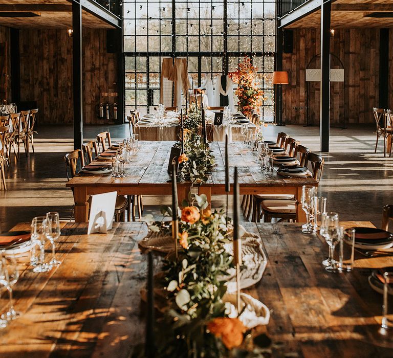 Hidden River Barn decorated with autumnal decorations, black taper candles, orange leaf flower columns