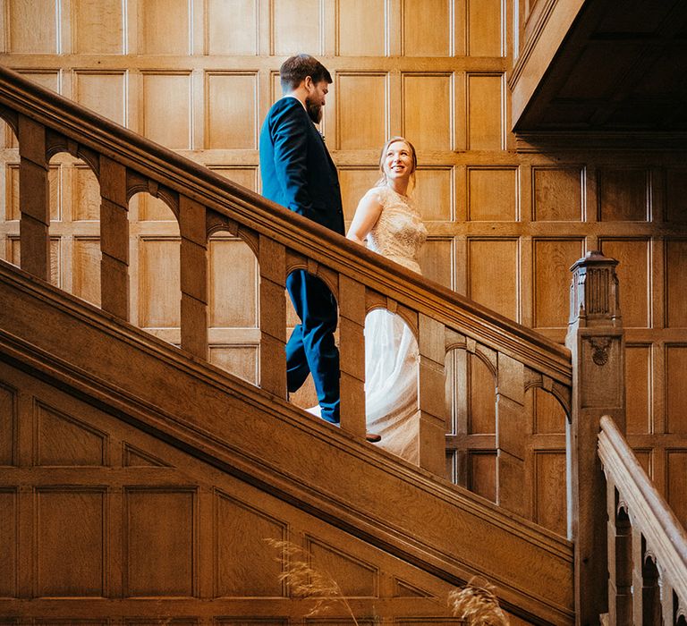 Coombe Lodge wedding with bride and groom walking down the stairs 