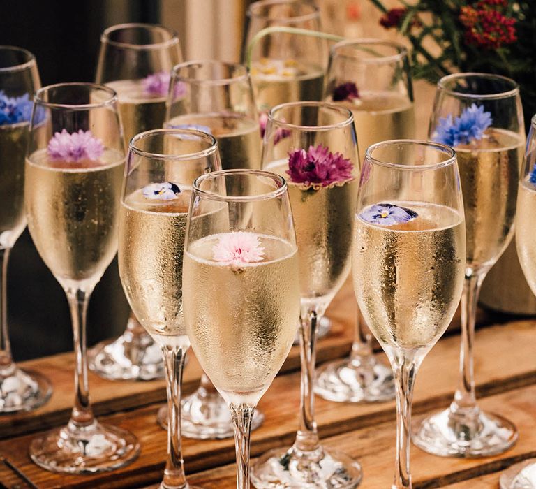 Edible flowers in glasses of champagne grown by the happy couple 