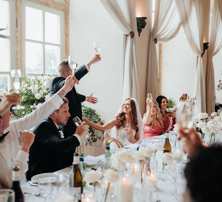 The wedding guests participate in a toast for the bride and groom on their wedding day 