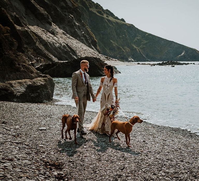 Bride and groom at beach wedding with their pet dogs 