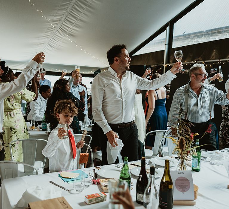 Wedding guests toast to the newlyweds at Wales wedding 