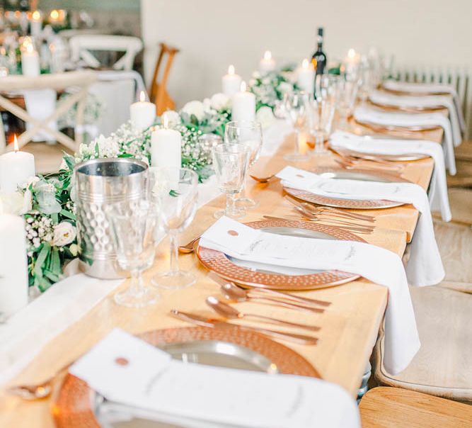 Place settings with copper charger plates and cutlery