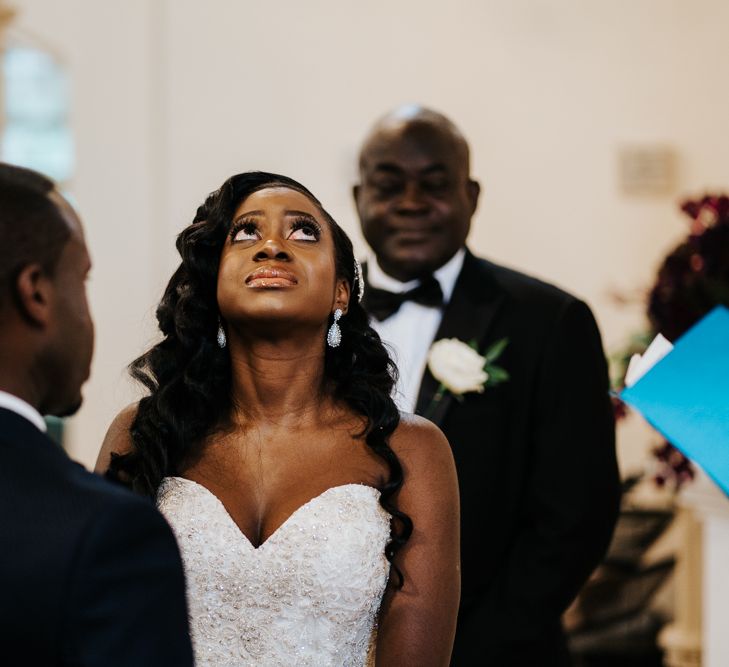 Emotional bride in strapless wedding dress during the wedding ceremony 