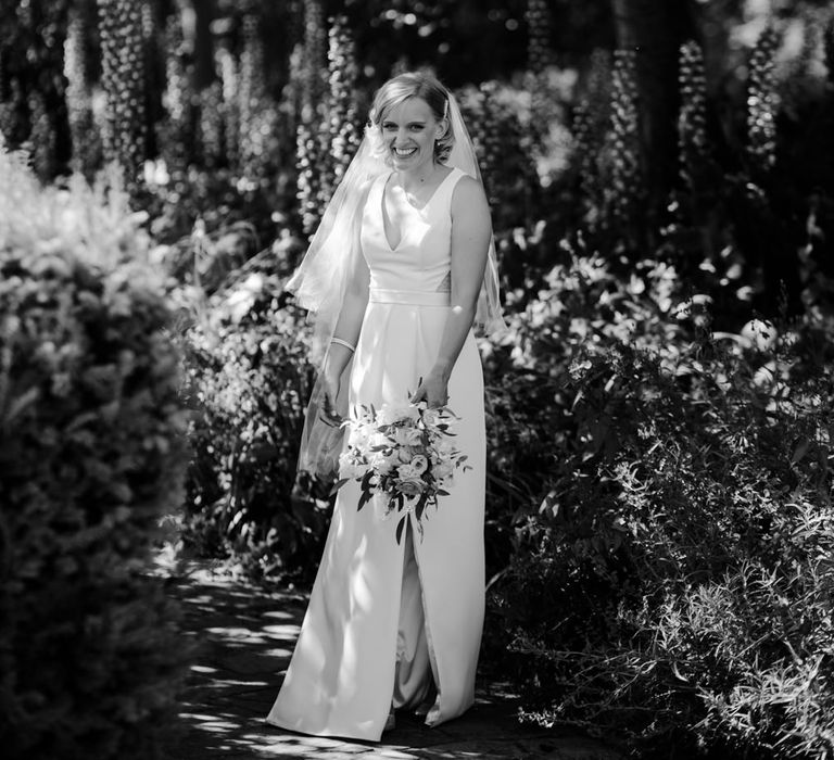 Bride in White by Vera Wang wedding dress with front split