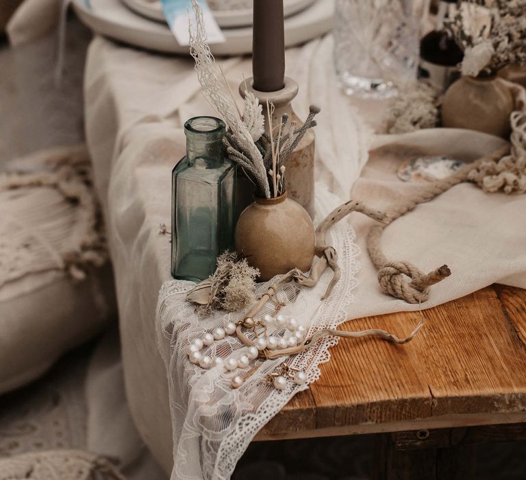 Ink wells filled with dried flowers at beach elopement 