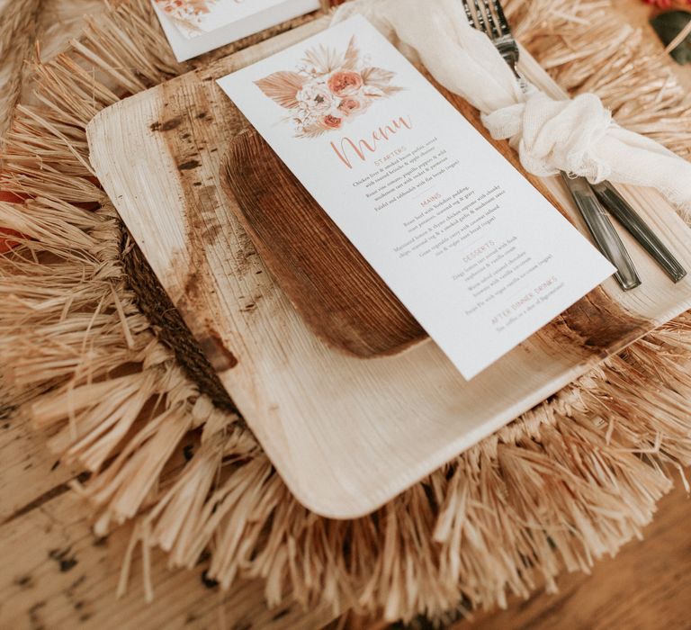 Table decoration with wooden plates and stationery 