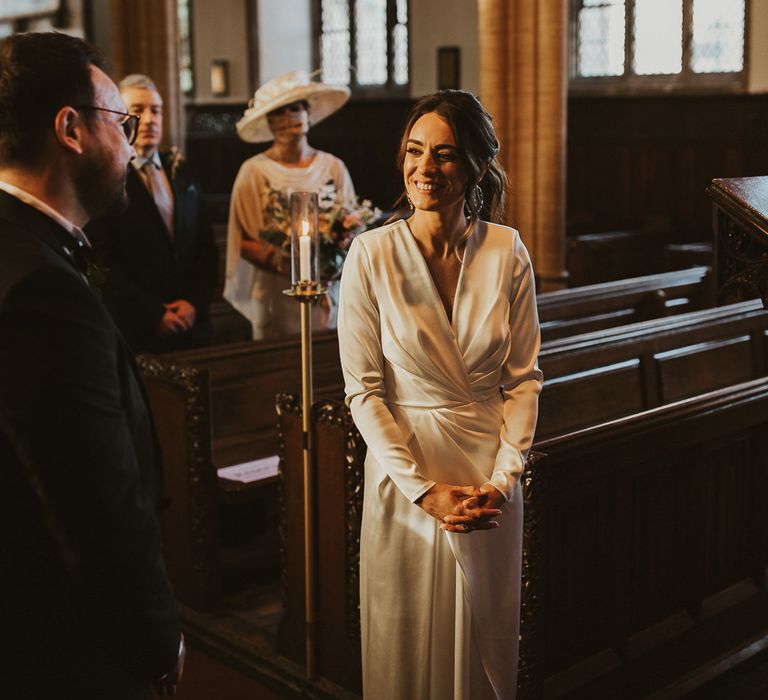 Bride & groom look at each other during wedding ceremony