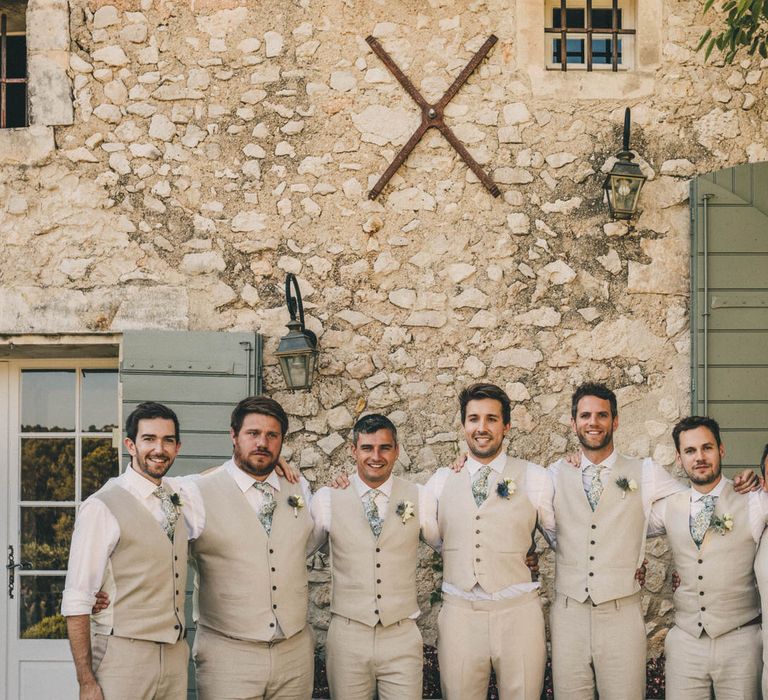 The groomsmen wearing matching M&S suits