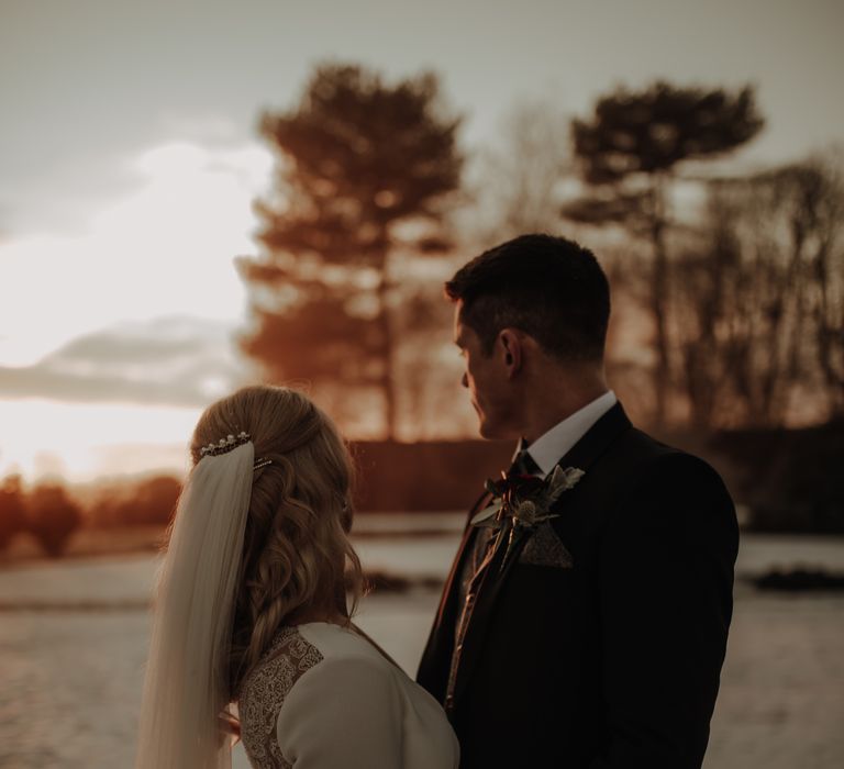 Bride wears long sleeve Pronovias wedding dress with veil