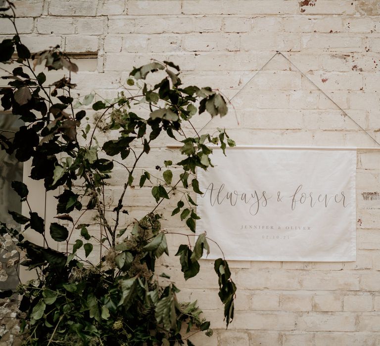 Always and forever fabric wedding sign hanging in the glasshouse reception 