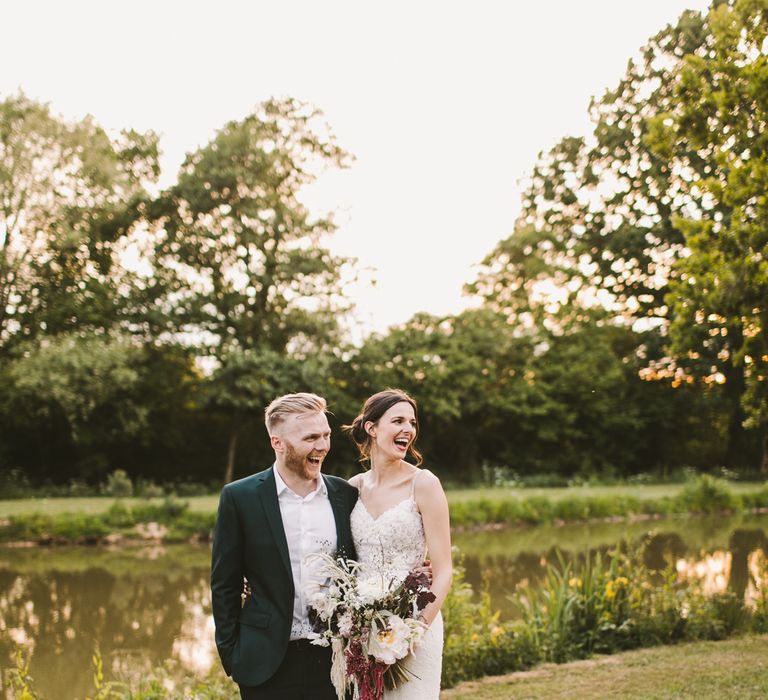 Bride & groom stand together in the countryside